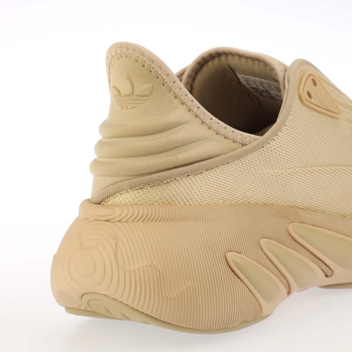 Beige trainers with padded collar, adidas heel logo, sculpted midsole