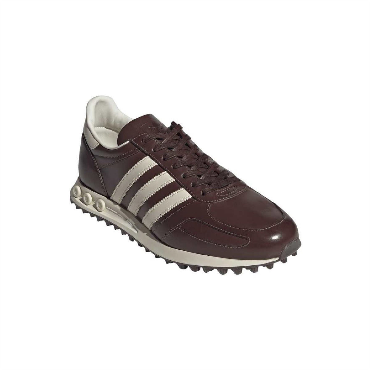 Dark brown lace-up sneaker side profile with white stripes and chunky tread sole