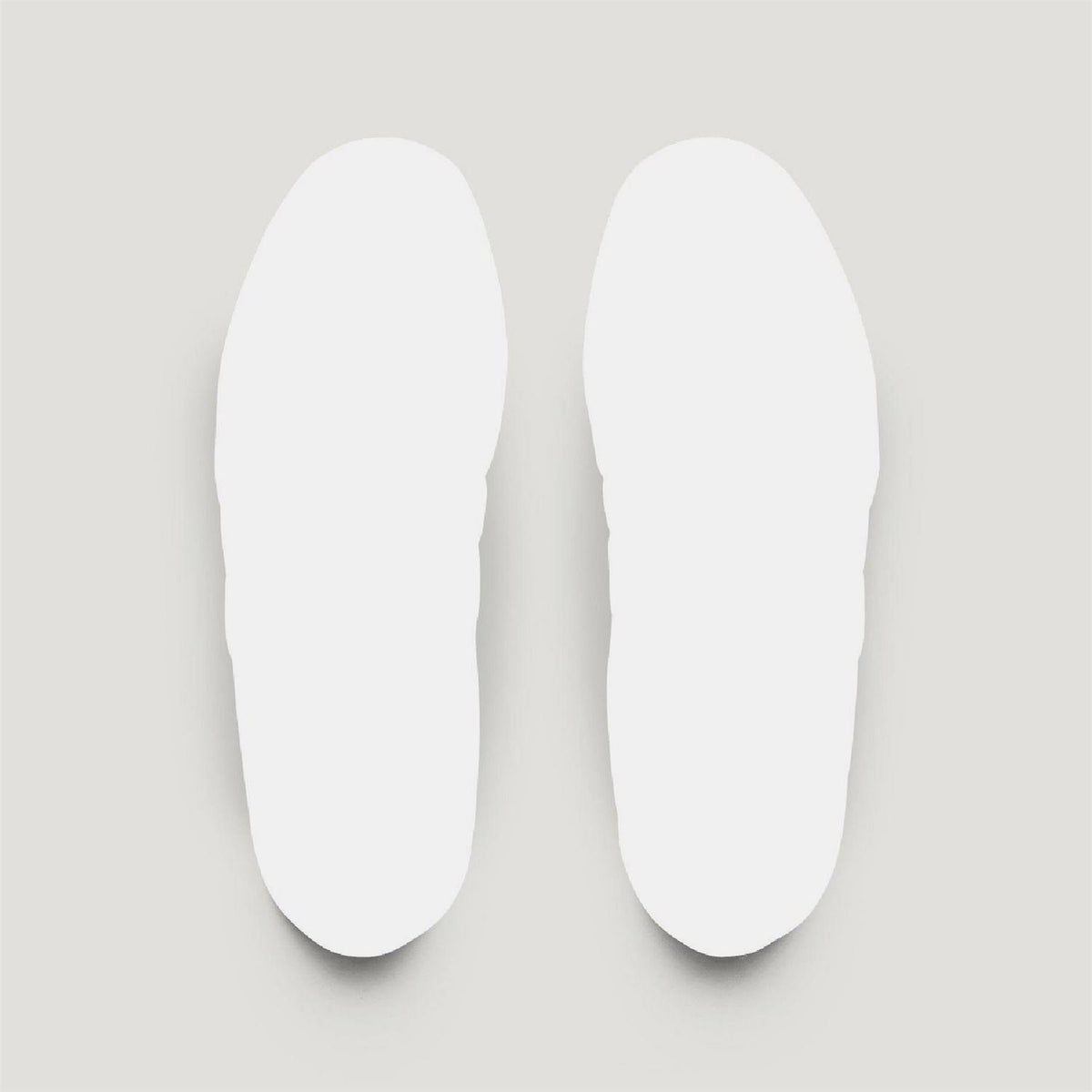 Pair of white shoe insoles, smooth and contoured