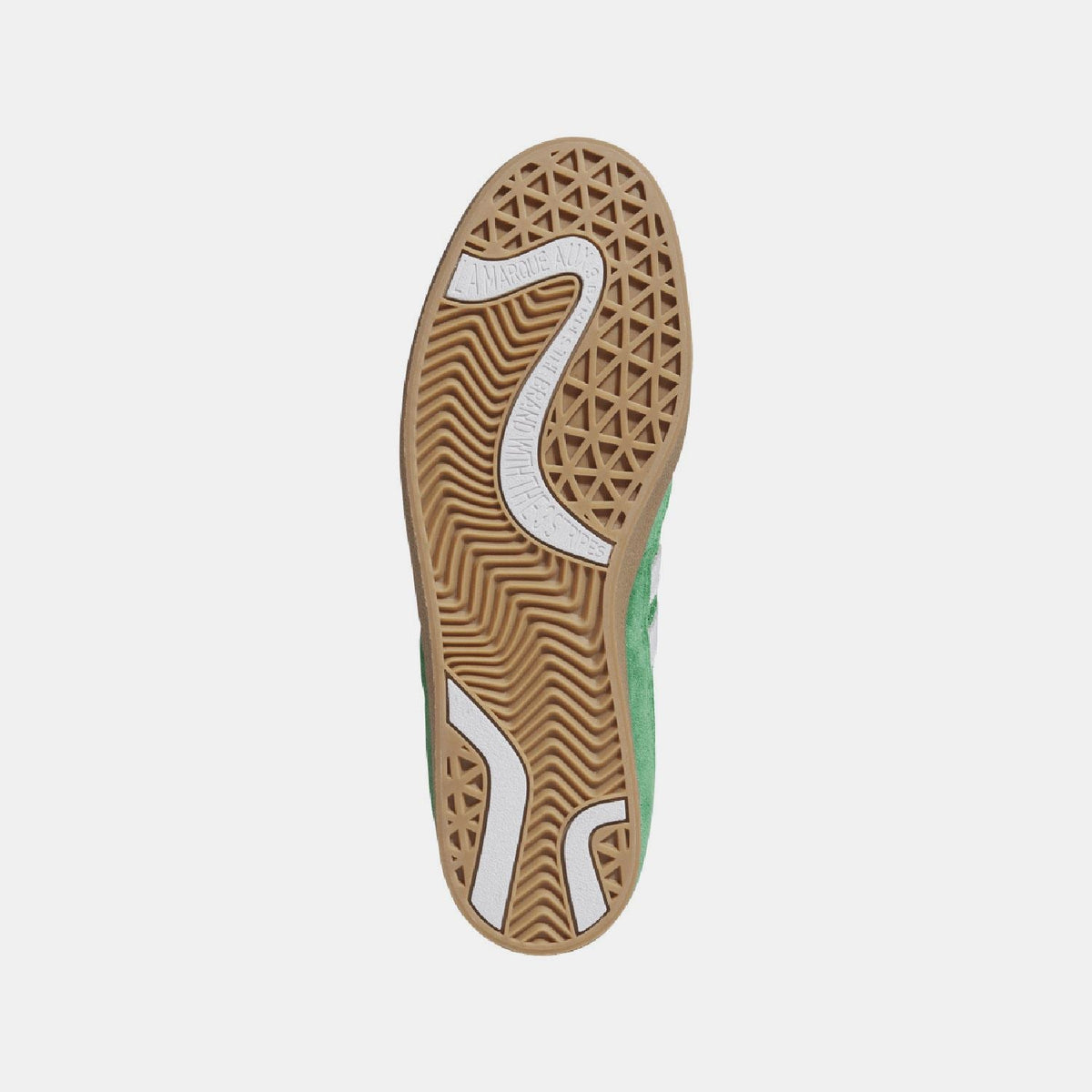 Gum outsole with patterned traction and white adidas logo on green trainer