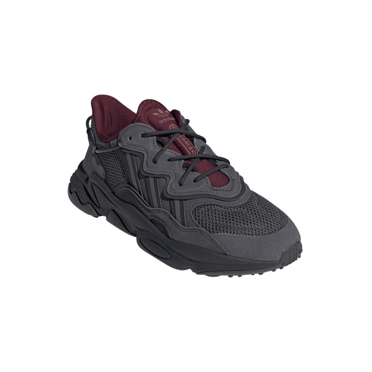 Grey sneaker side view with burgundy collar and lace-up mesh upper