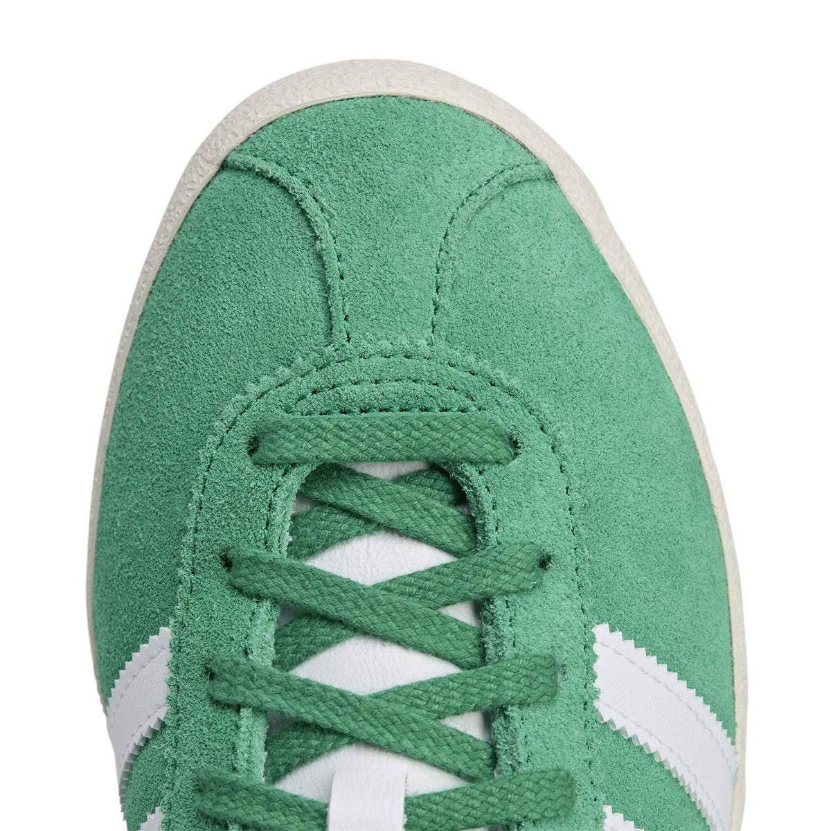 Close-up of court green lace-up front with white stripe overlays and adidas branding