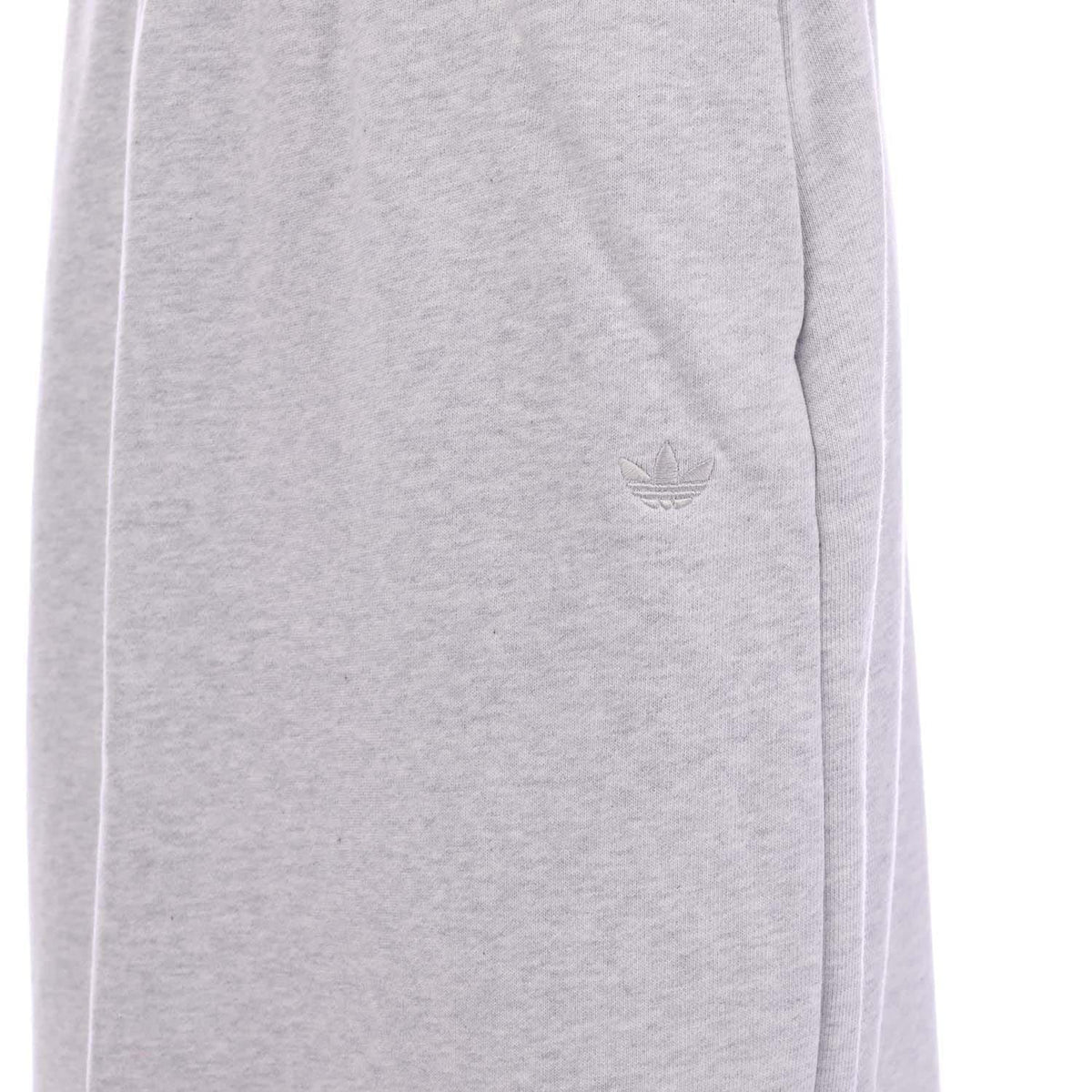 Light grey skirt fabric close-up with embossed adidas trefoil logo