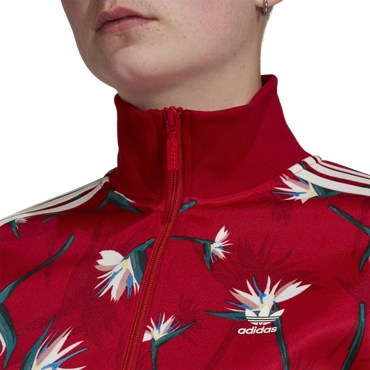 Red high-neck zip athletic top with floral print and adidas logo