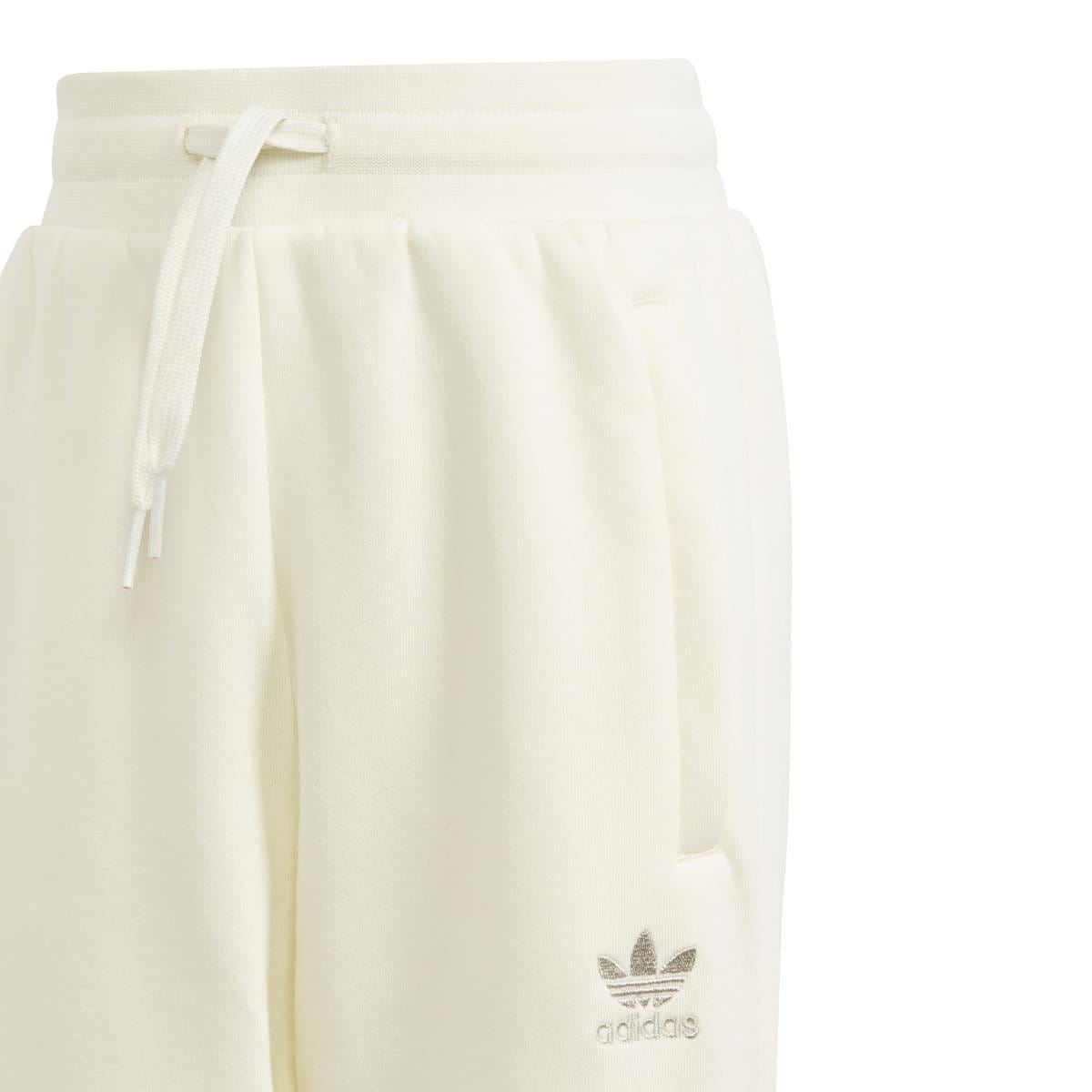 Kids' cream joggers close-up with drawstring waistband and adidas trefoil print