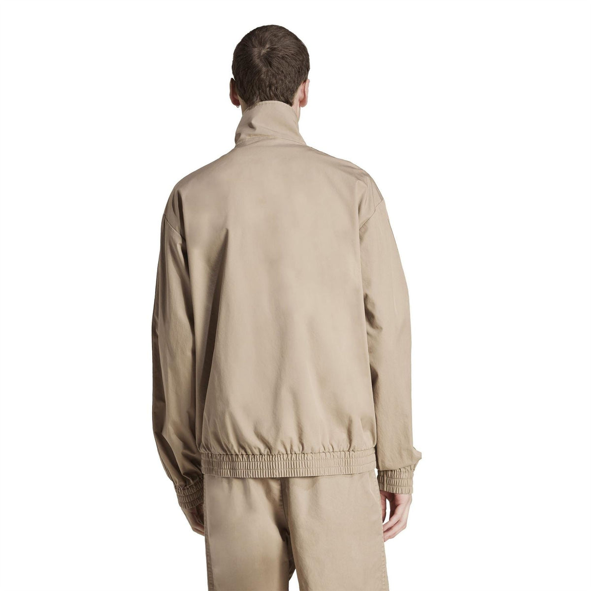 Beige track jacket, back view, with elastic hem and stand collar