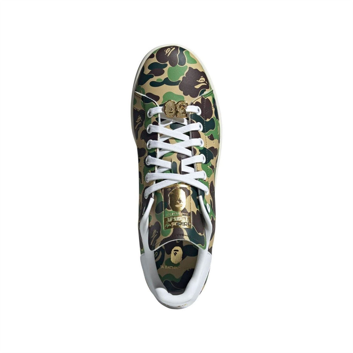 Stan Smith sneaker top view, green/brown camo upper, white laces with gold lace-lock