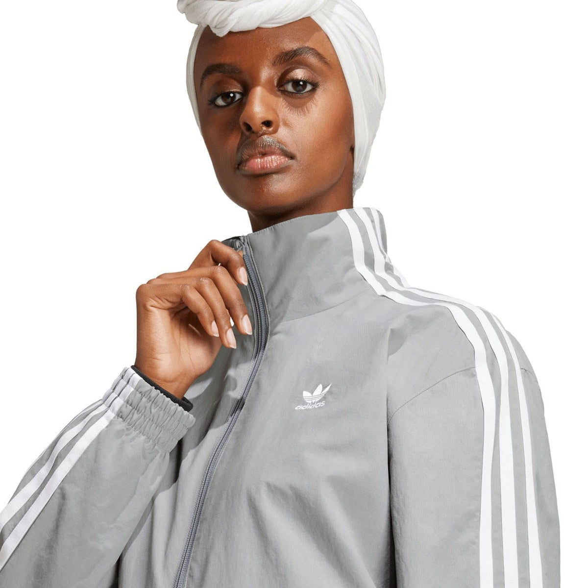 adidas Originals grey woven track jacket close-up of zip and shoulder stripes