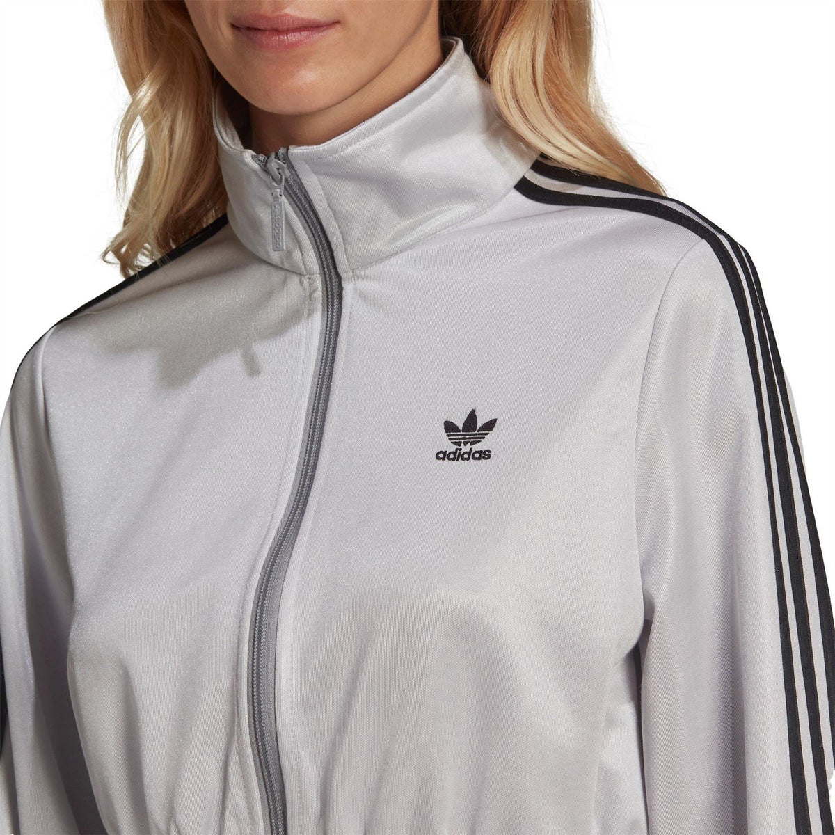 Silver high-neck track top with front zip and adidas logo, black shoulder stripes