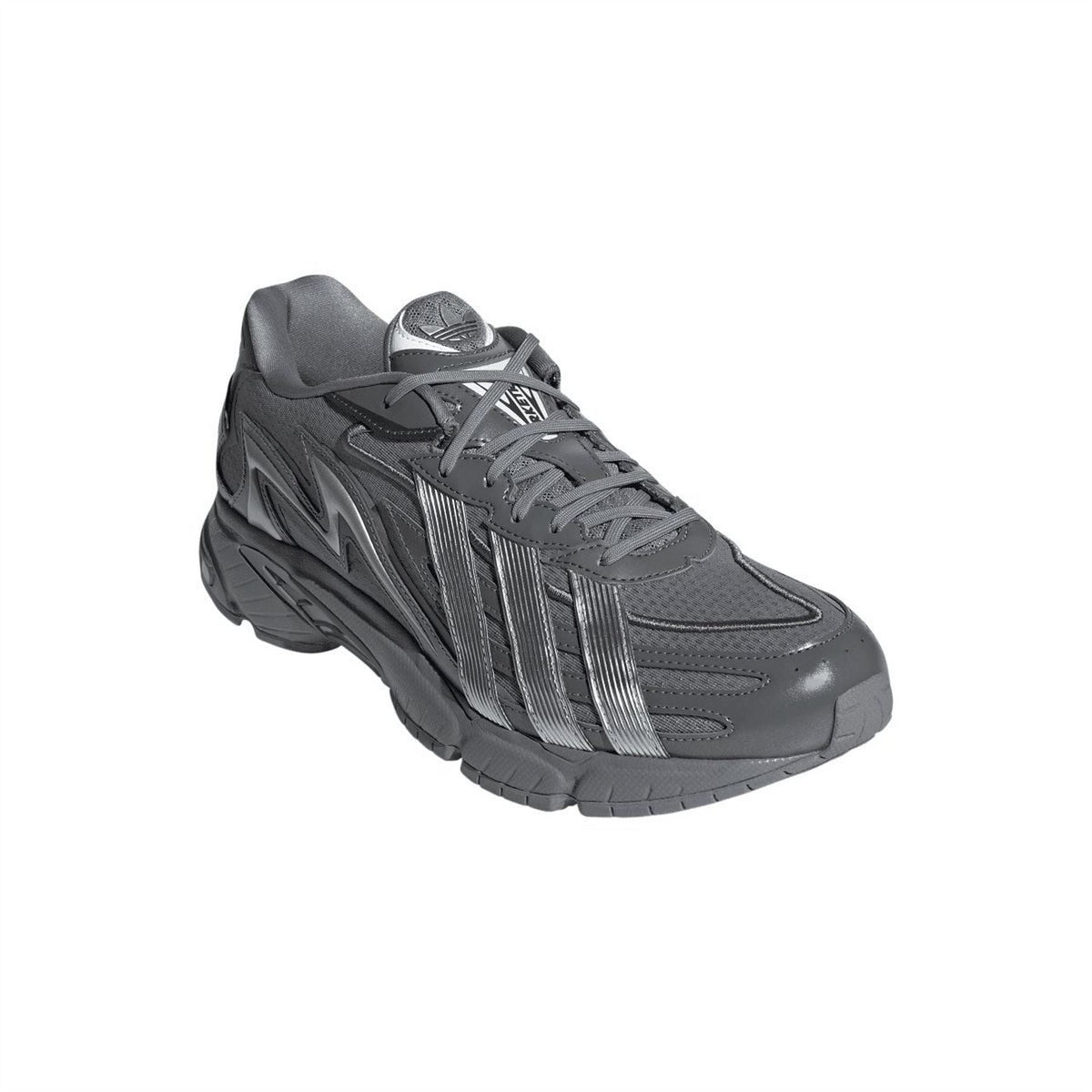 Grey lace-up trainers with padded tongue, striped side detailing, and chunky sole