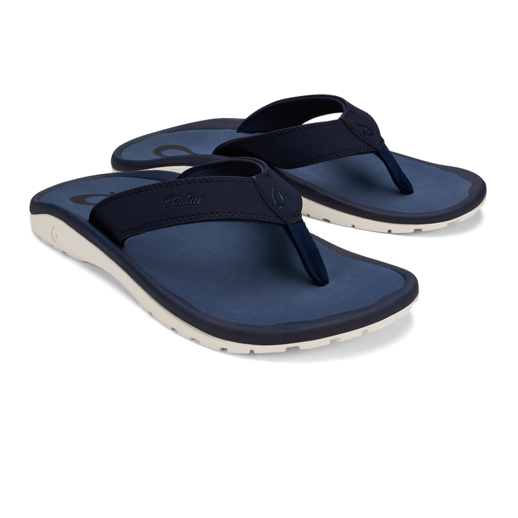 Navy blue thong sandals with cream sole and OluKai branding