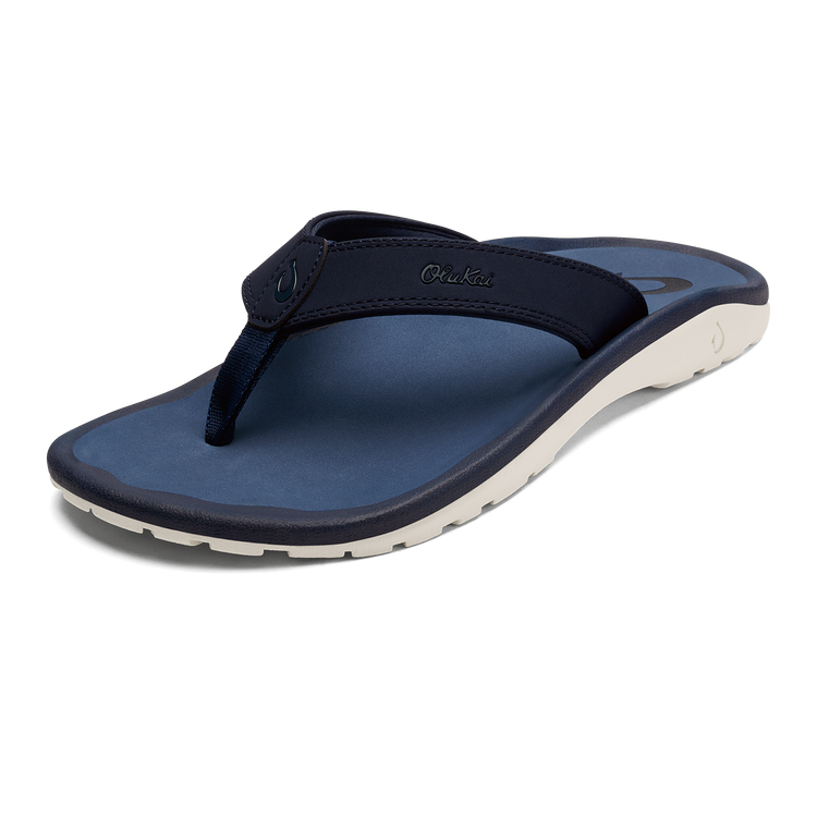 Dark blue thong sandals with curved strap and cream outsole