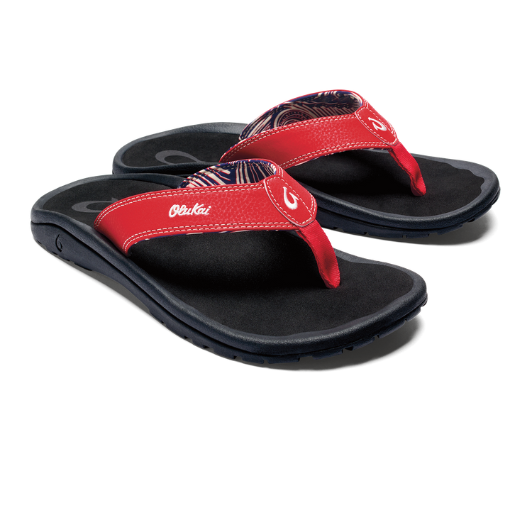 Red thong sandals with black sole and OluKai logo strap