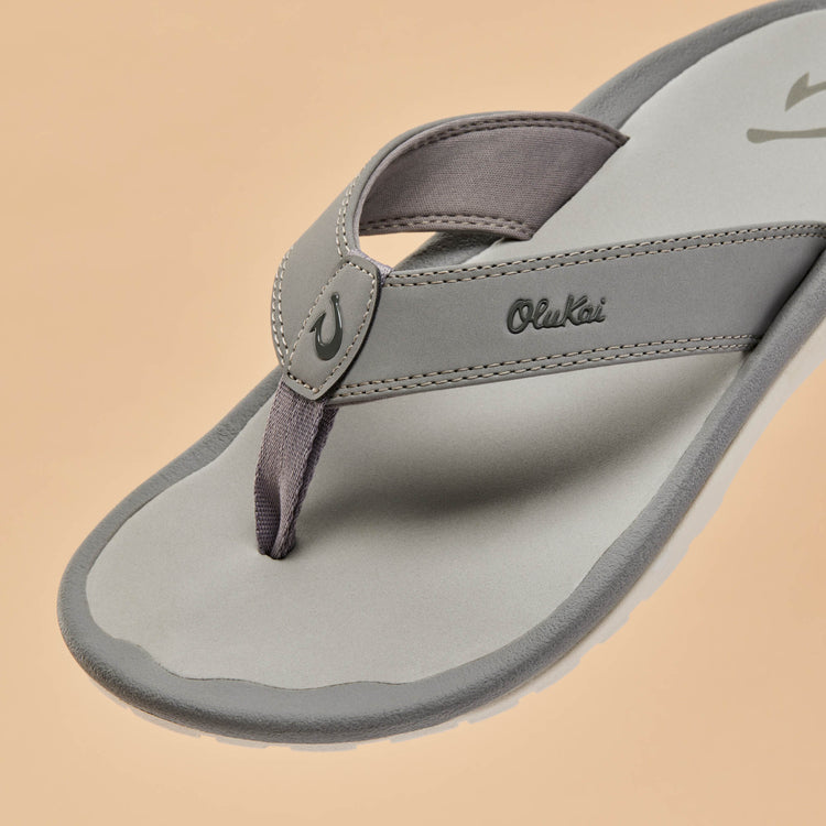 Close-up of gray thong sandal strap and footbed logo