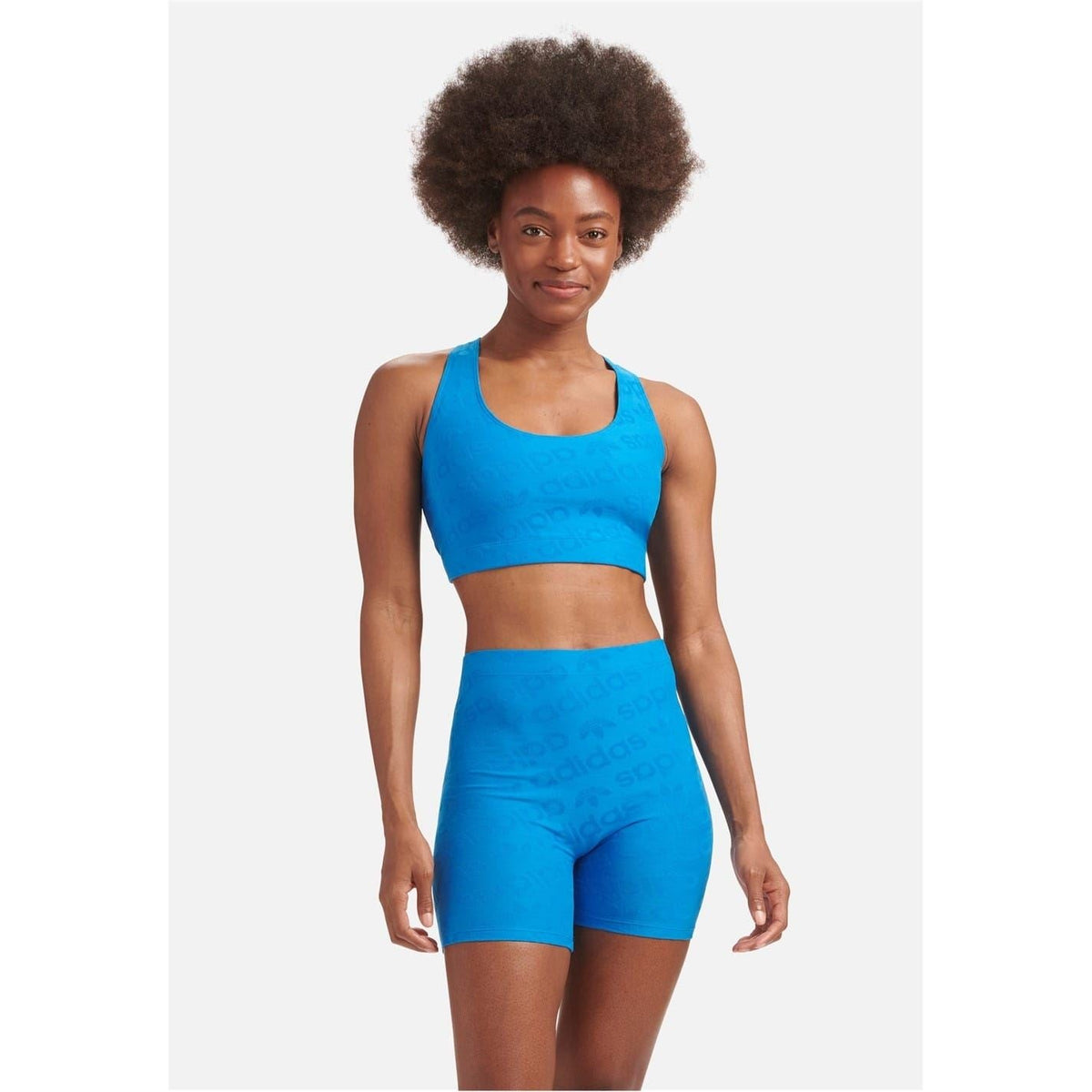 Women's blue racer back crop top with wide scoop neck and racerback straps.