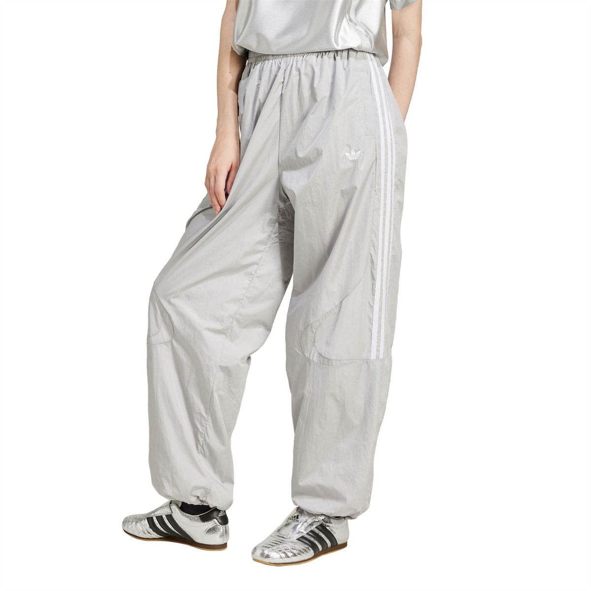 Light grey windbreaker track pants with side stripes and elastic cuffs