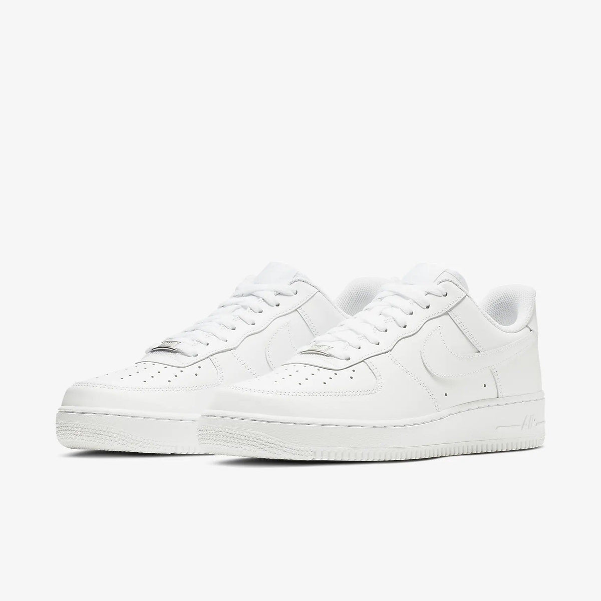 Pair of white low-top sneakers with rounded toe and lace-up closure