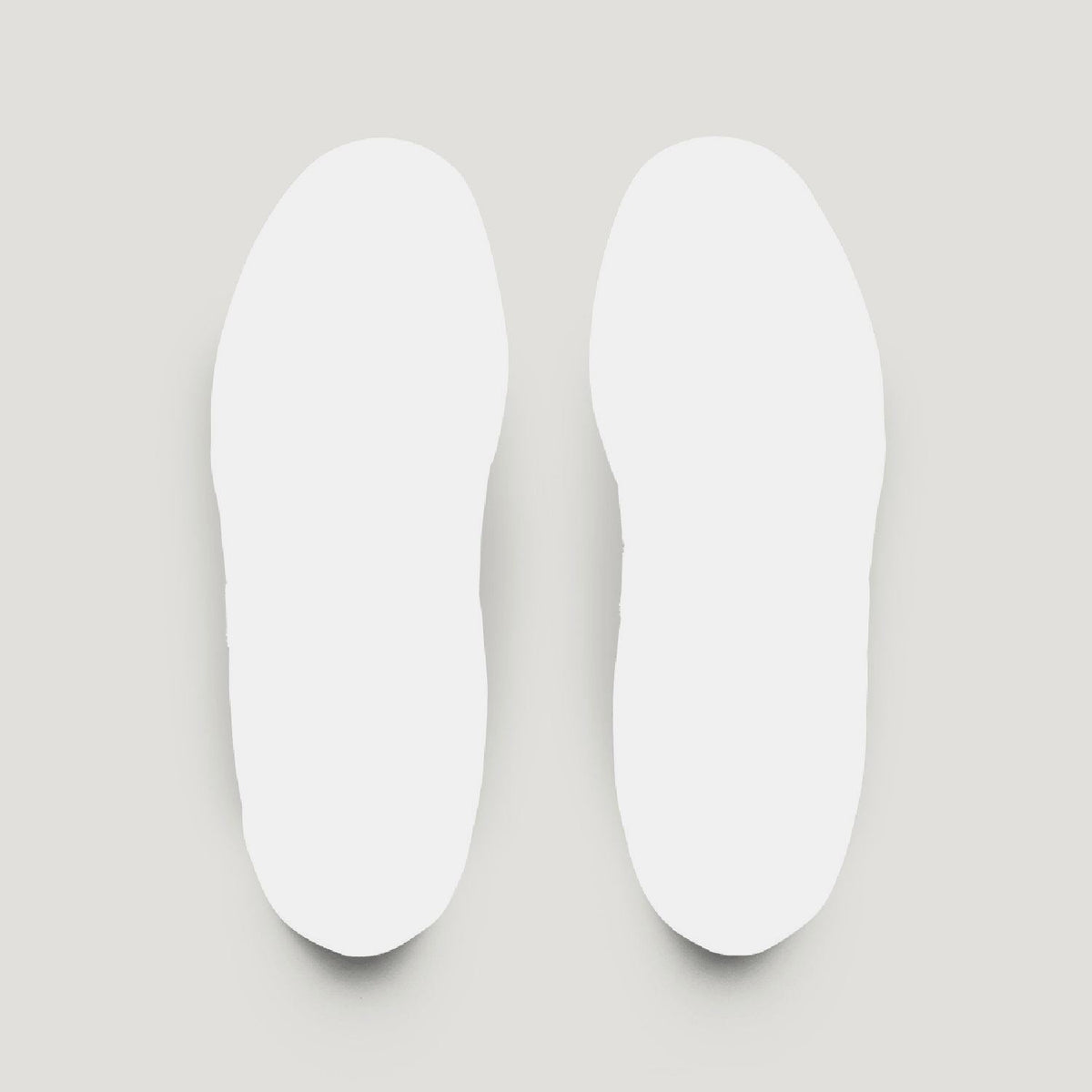 Pair of white removable insoles for low-top trainers.