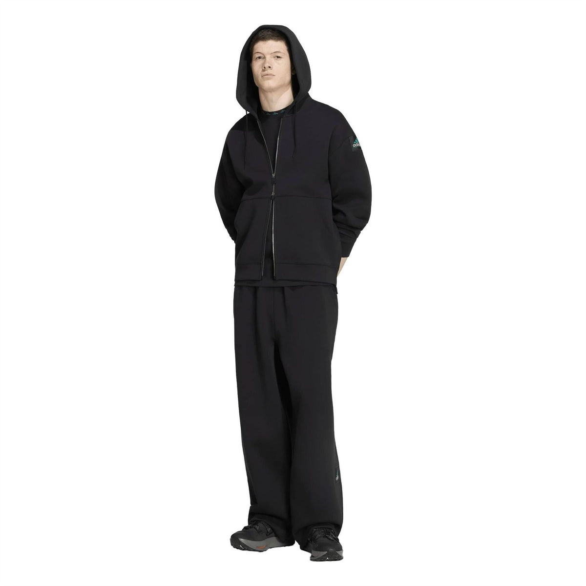 adidas Originals EQT pants worn with a black hooded jacket, relaxed wide-leg fit