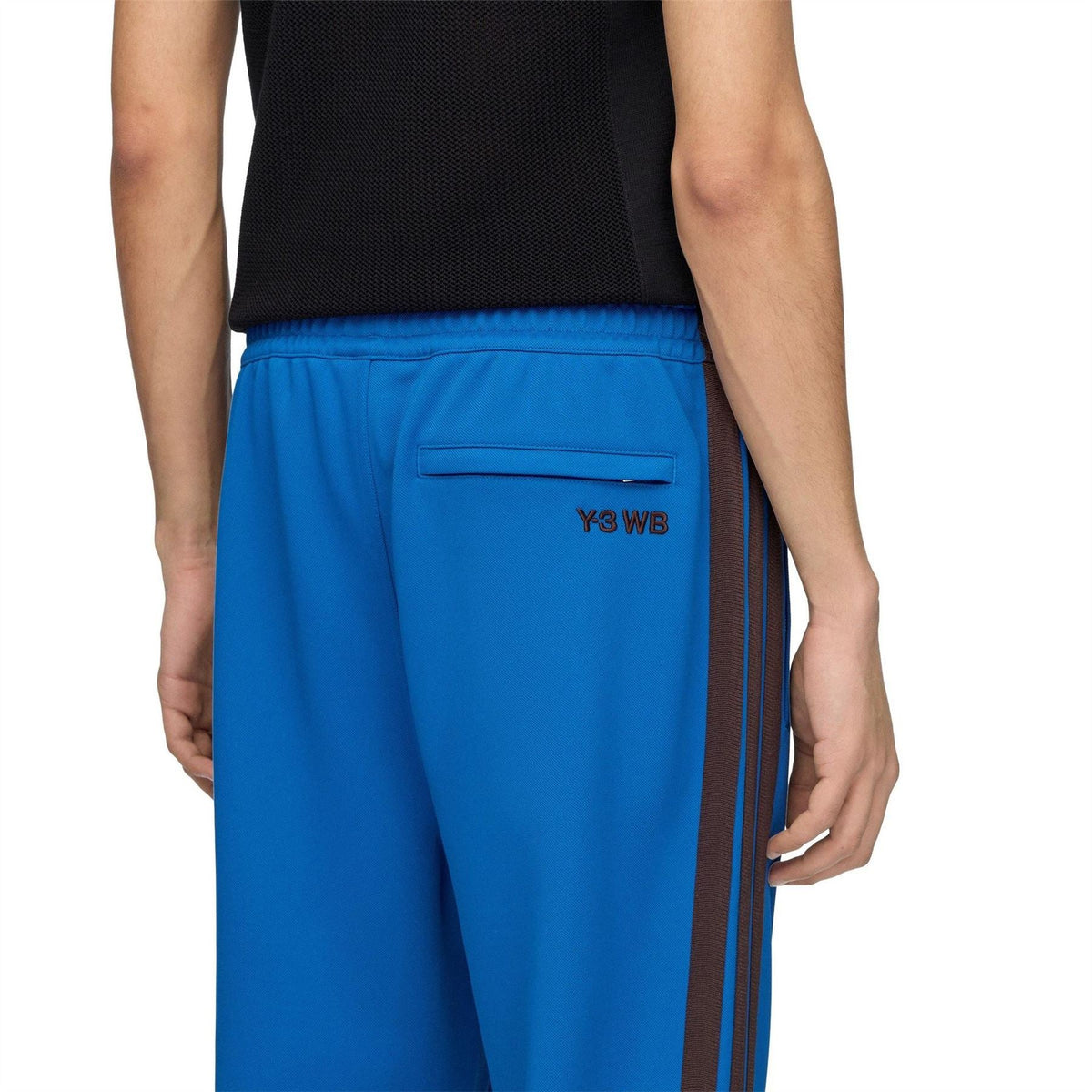 Men's blue track pants with dark side stripes and 'Y3 WB' pocket logo