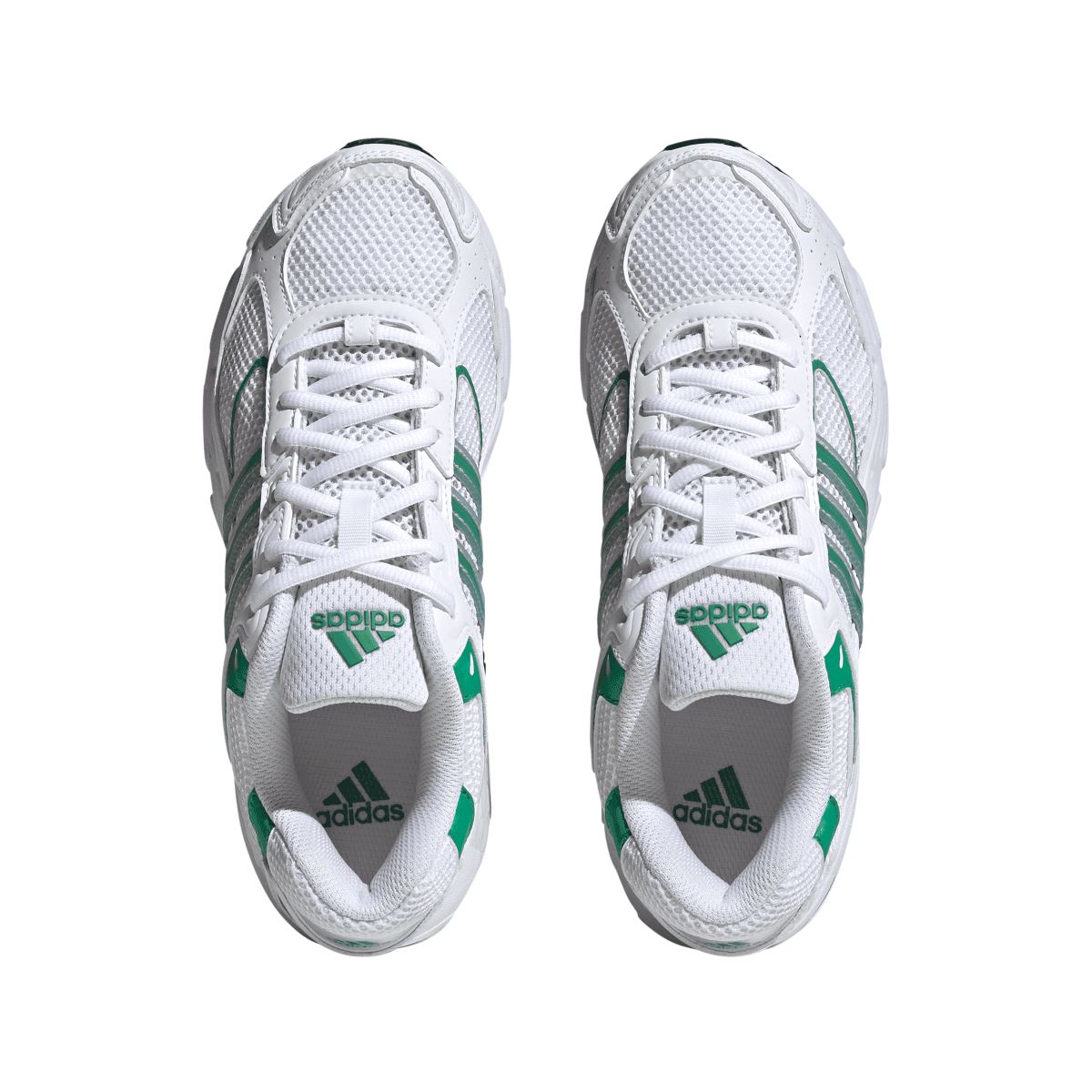 Pair of white trainers with green accents, white laces, and cushioned tongue
