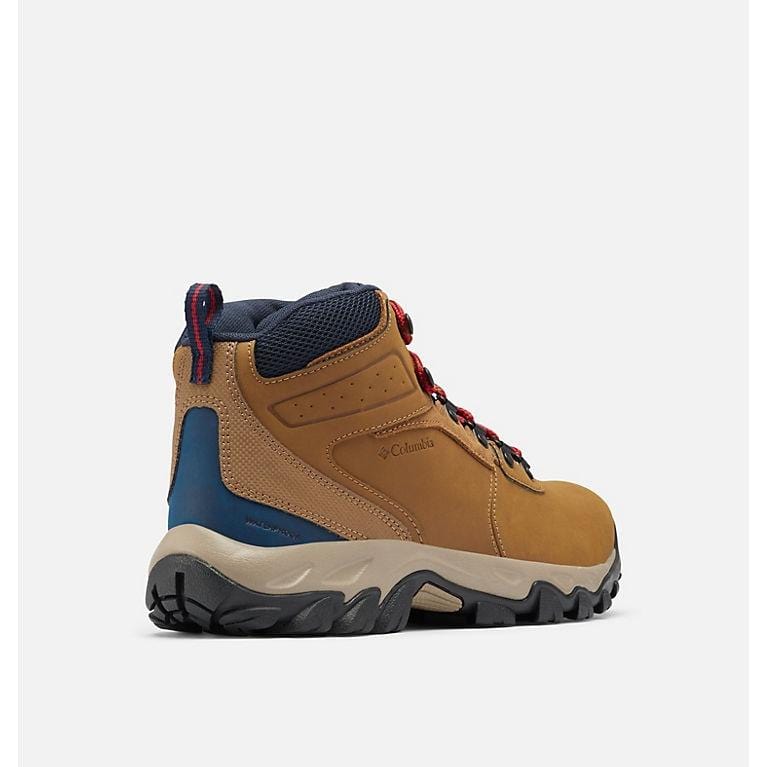 Hiking boots in tan with blue panels and red laces, black traction outsole