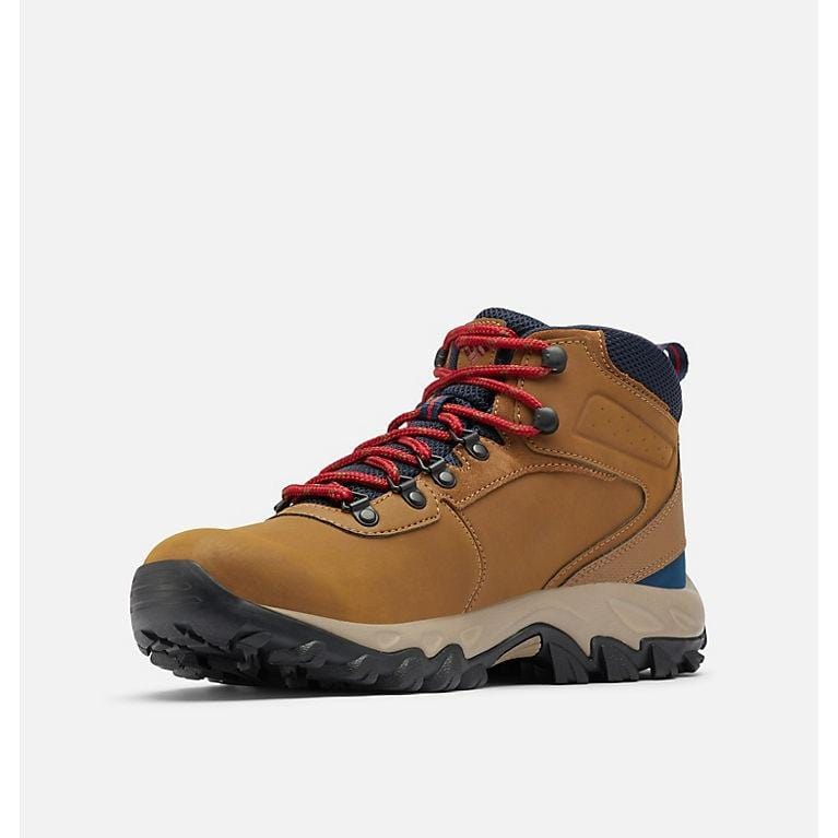 Hiking boots in tan with red laces, navy collar, and black rugged outsole