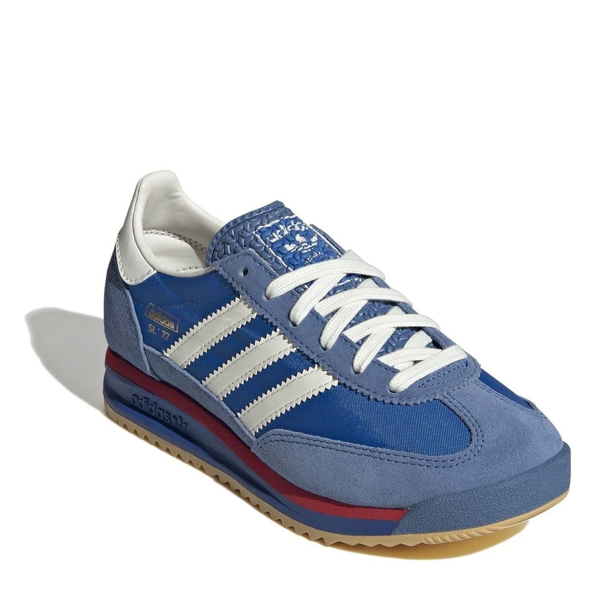 Blue suede low-top sneakers with white triple stripes, lace-up closure, gum sole