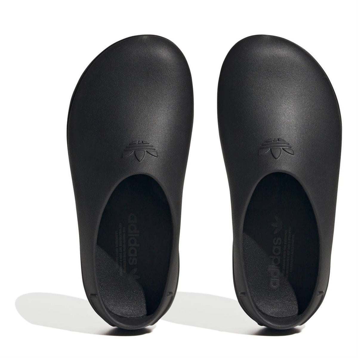 Black low-top trainers viewed from top, with embossed adidas-style logo at toe