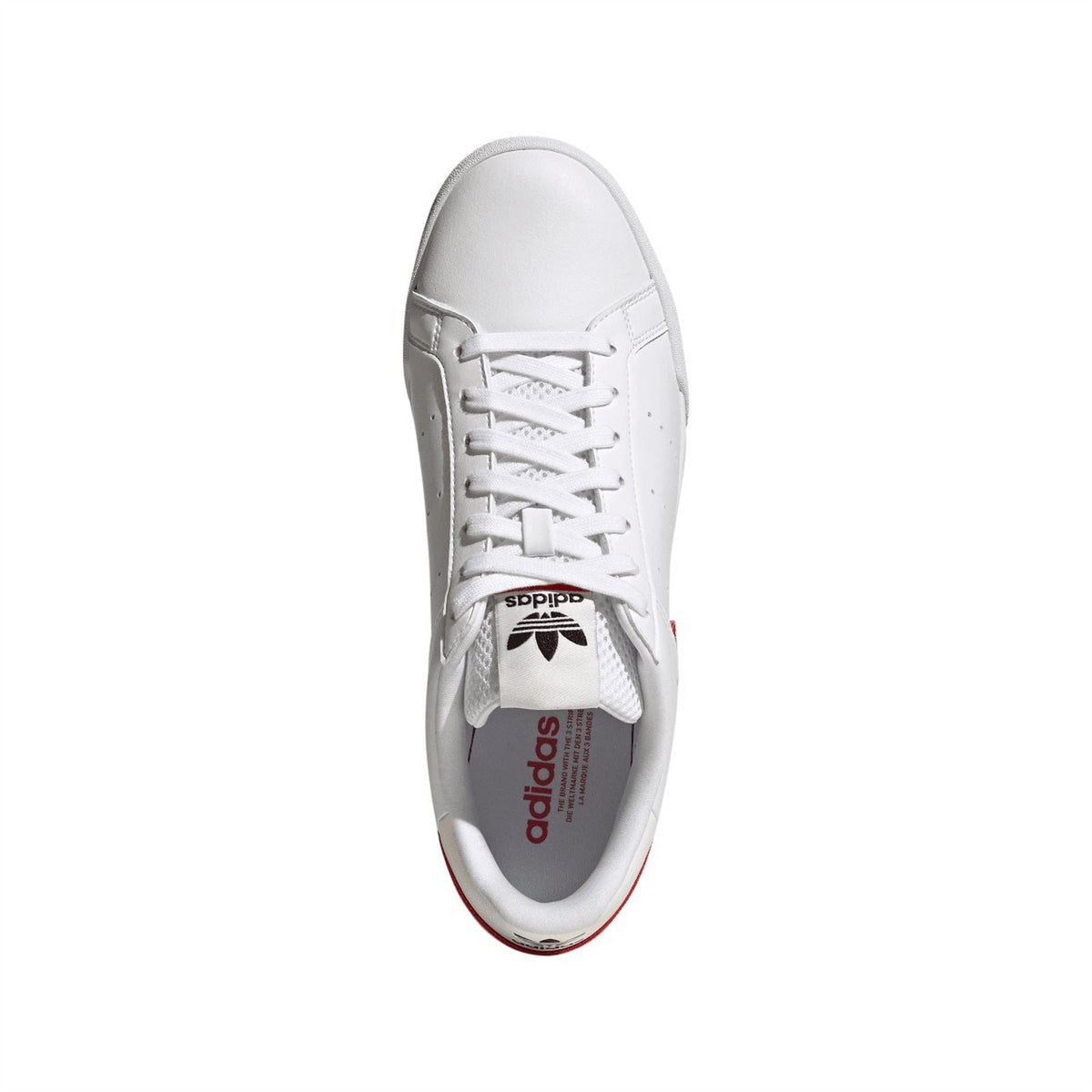 White adidas Tourino lace-up trainers with adidas logo on tongue