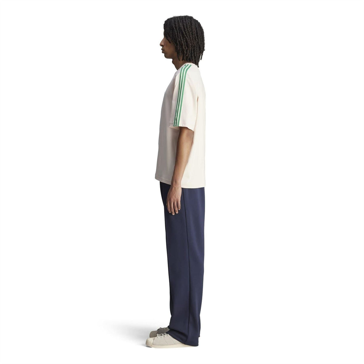 Cream logo T-shirt with green sleeve stripe trim, side view on model