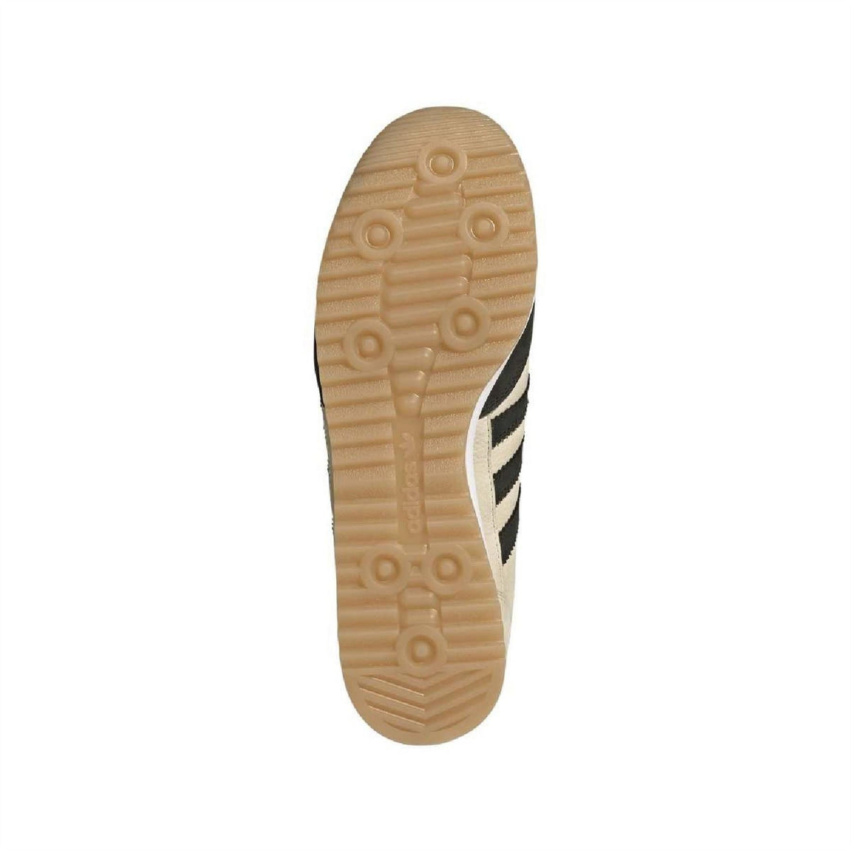 Beige adidas sneaker outsole bottom with tread pattern and black three-stripe panel