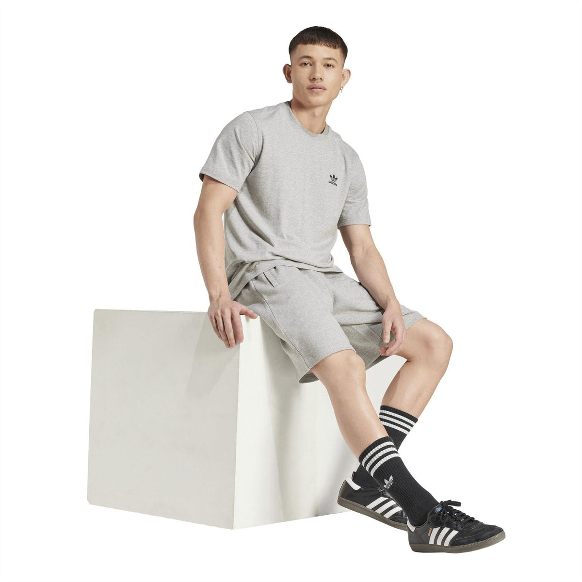 adidas Originals Ess shorts in medium grey heather, thigh logo and relaxed knee-length fit