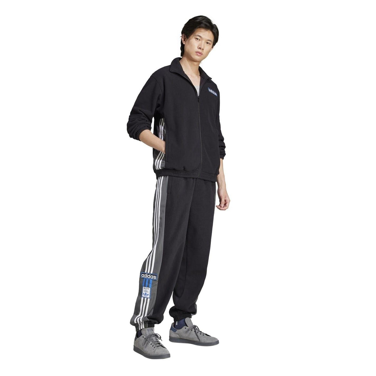 Black adidas funnel-neck zip-up sweatshirt worn with matching track pants