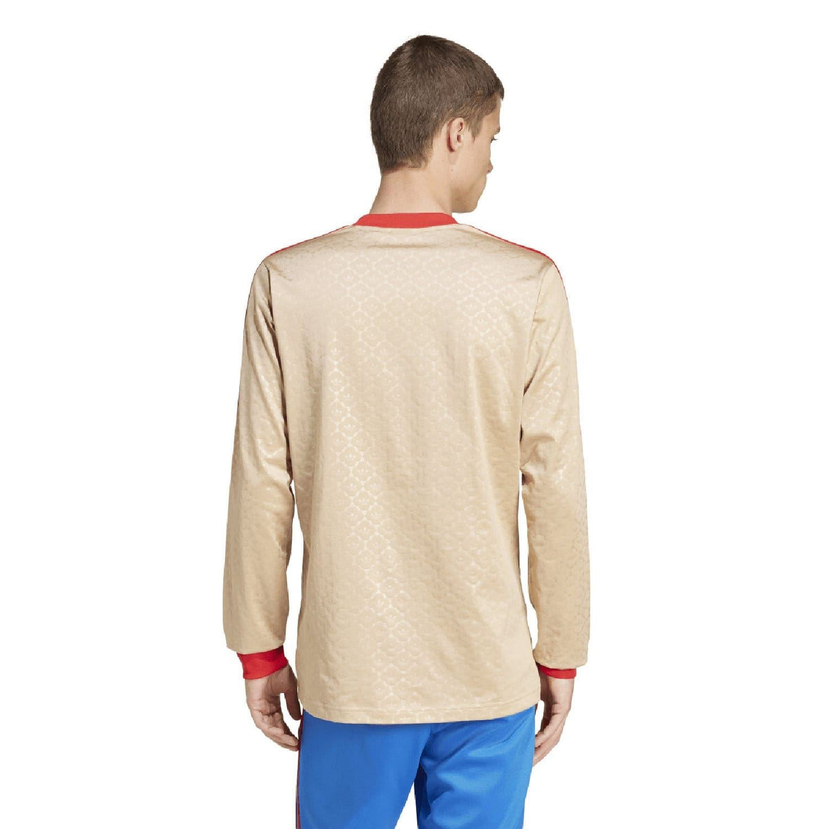 Beige adidas Originals jersey back view with red cuffs and subtle patterned fabric