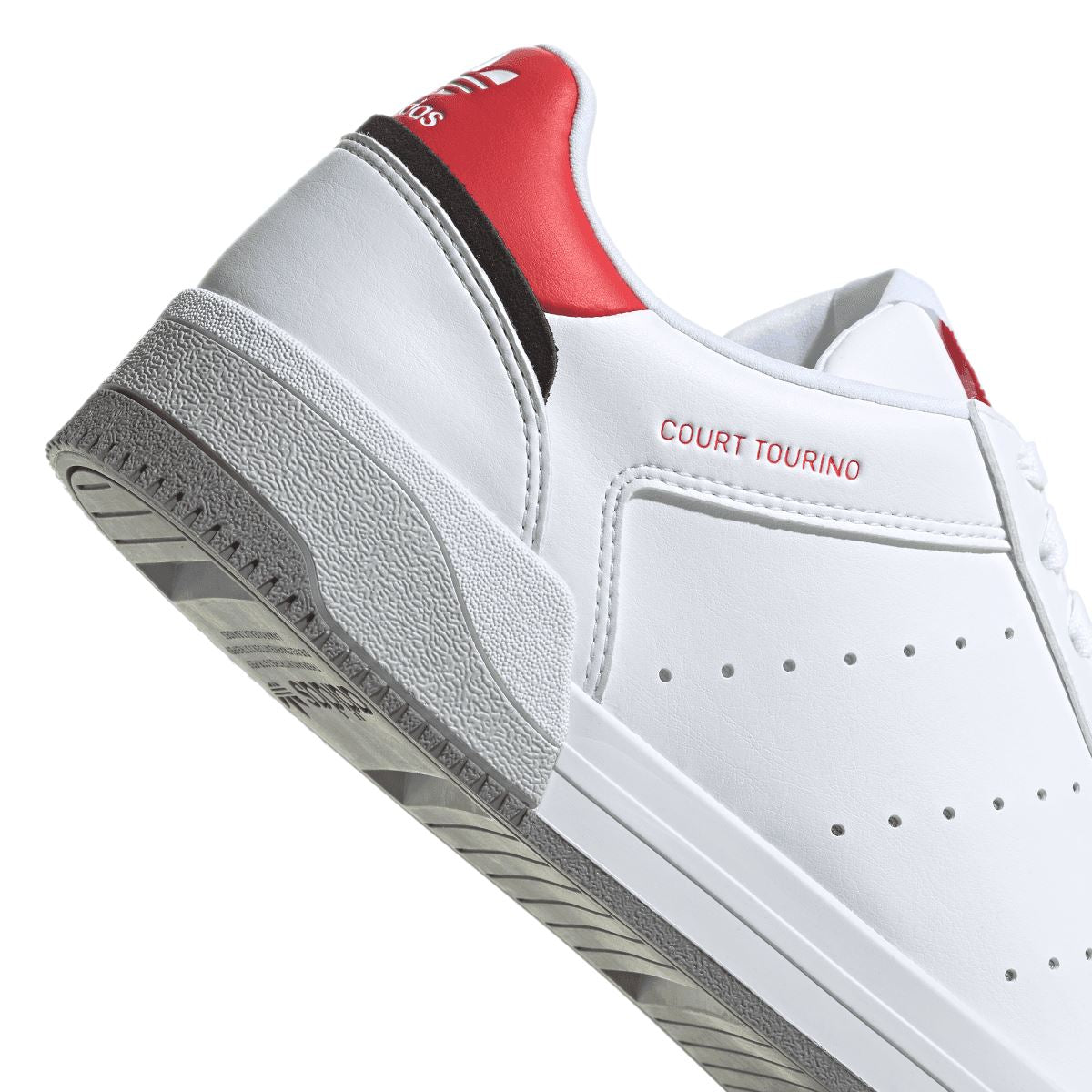Side detail of white adidas Originals trainers with red heel stripe and “COURT TOURINO”