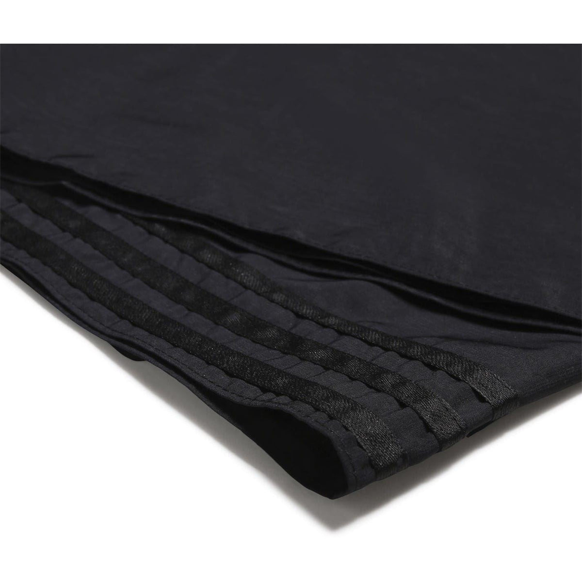 Black head scarf hem with raised ribbed stripe trim along the fold