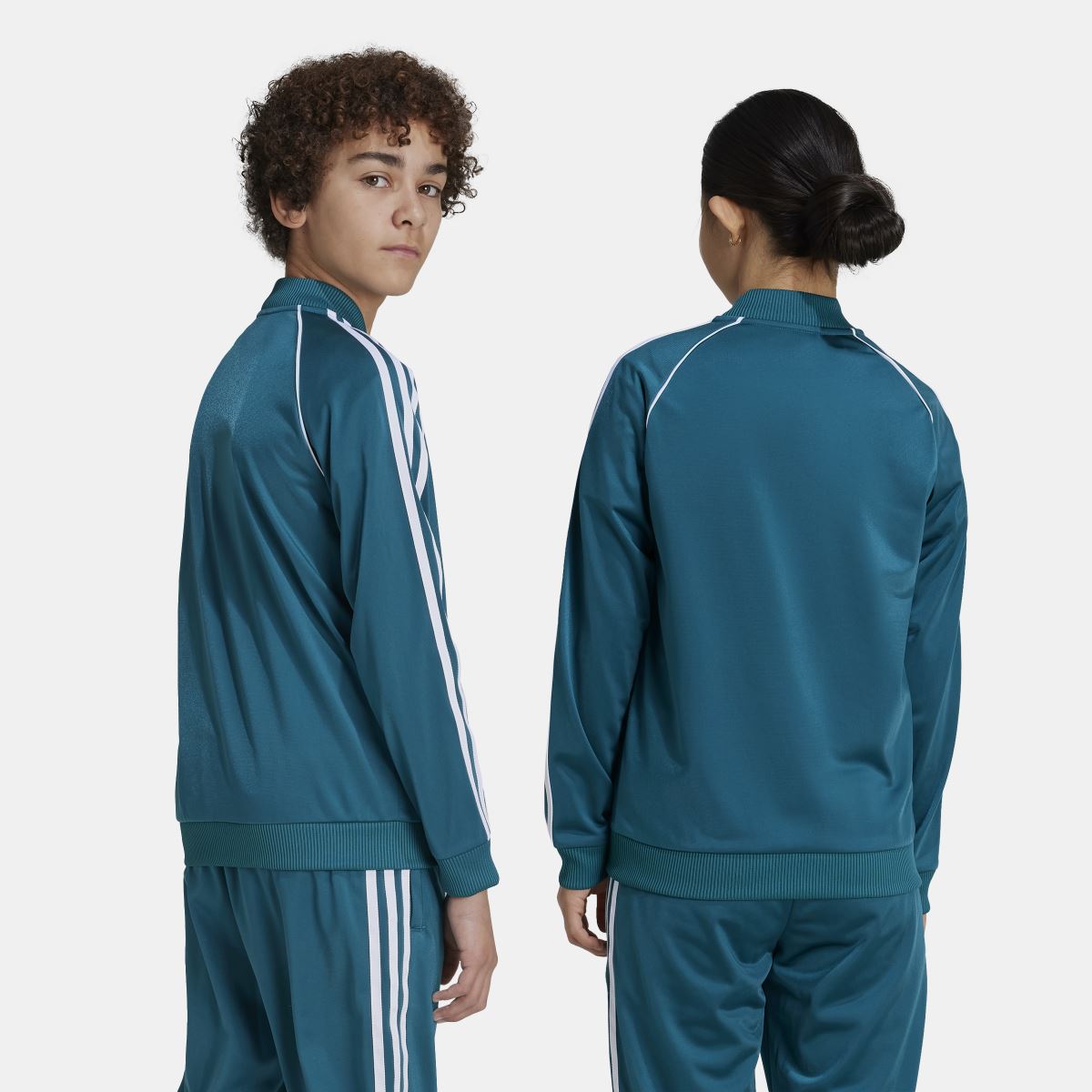 Teal kids track jacket back with white triple stripe sleeves and ribbed waistband.