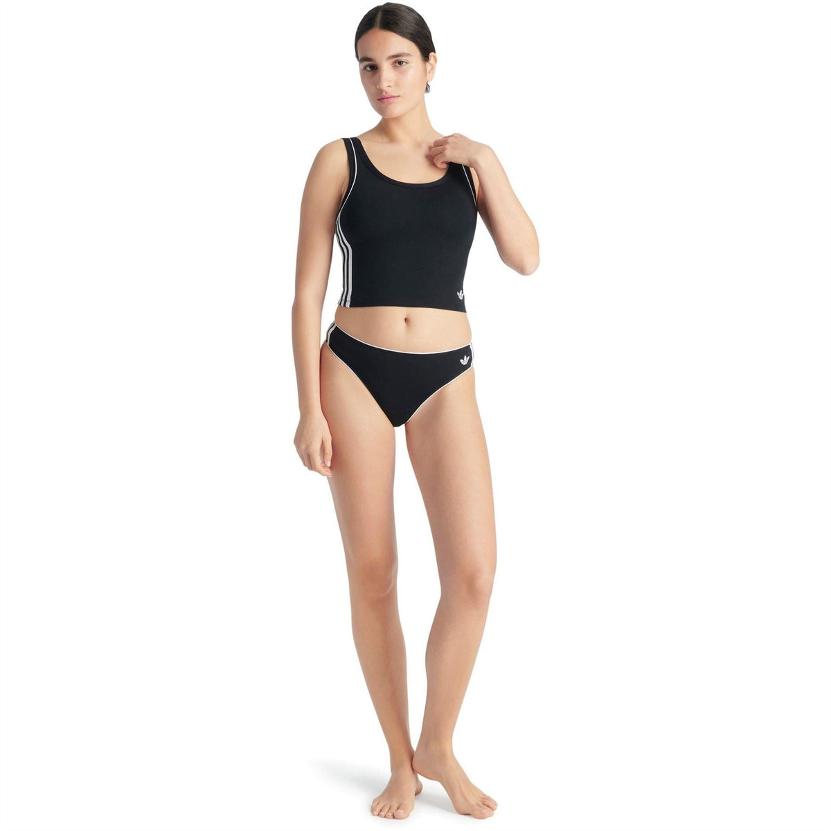Black cotton thong underwear with white side stripes, worn with matching crop top