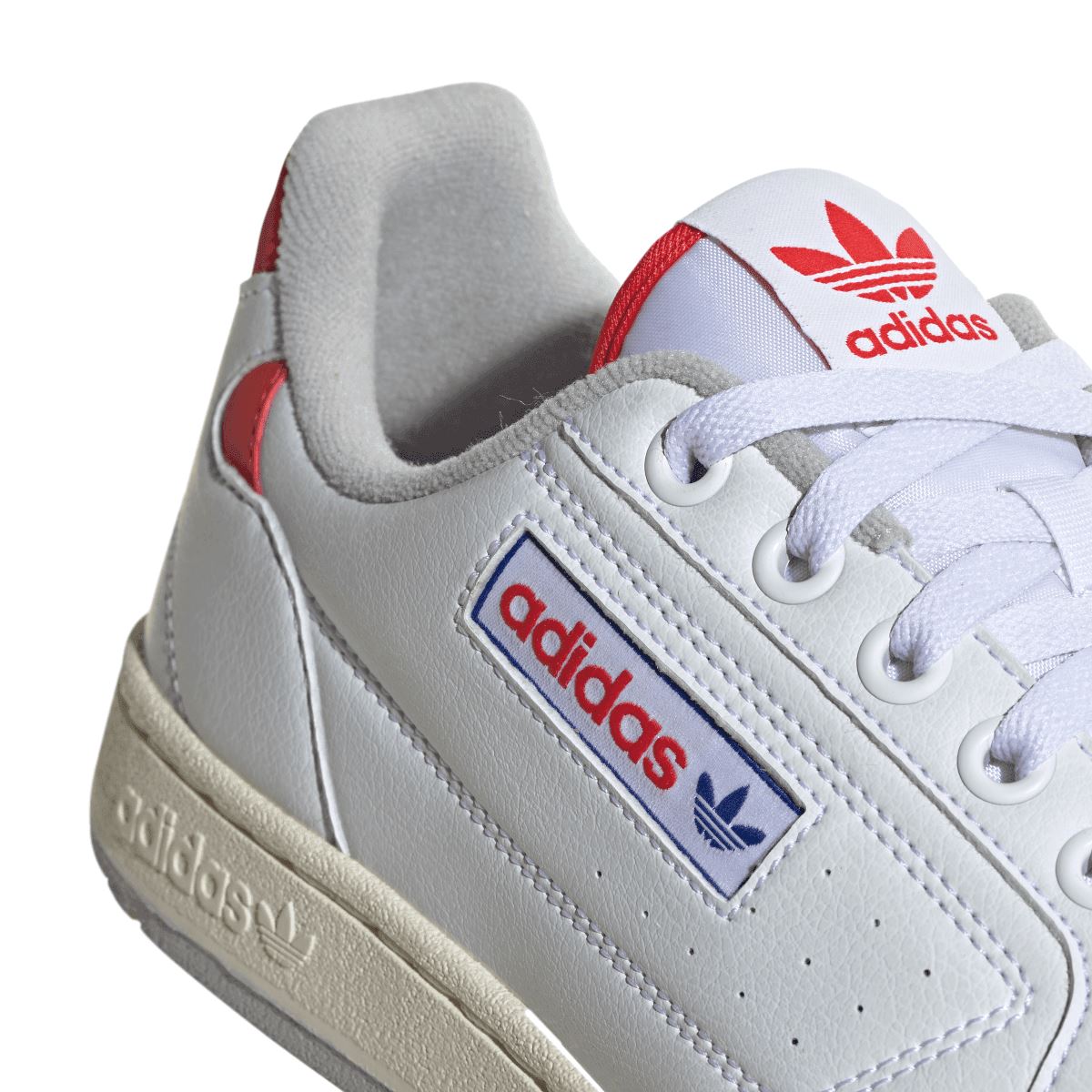 White adidas Originals NY 90 trainers close-up with adidas logo on side and laces