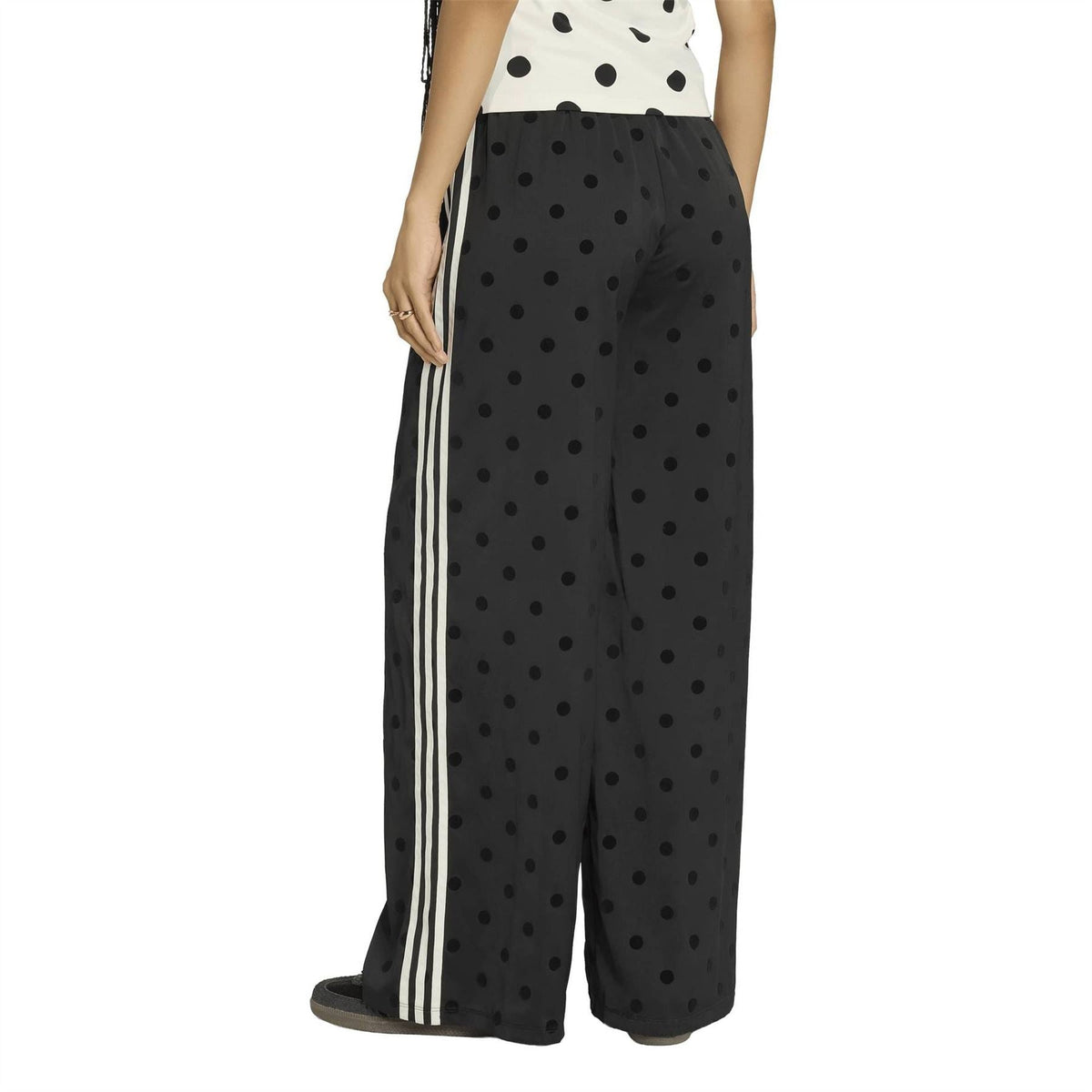 Black wide-leg pants with black polka dots, elastic waist, and white side stripe detail