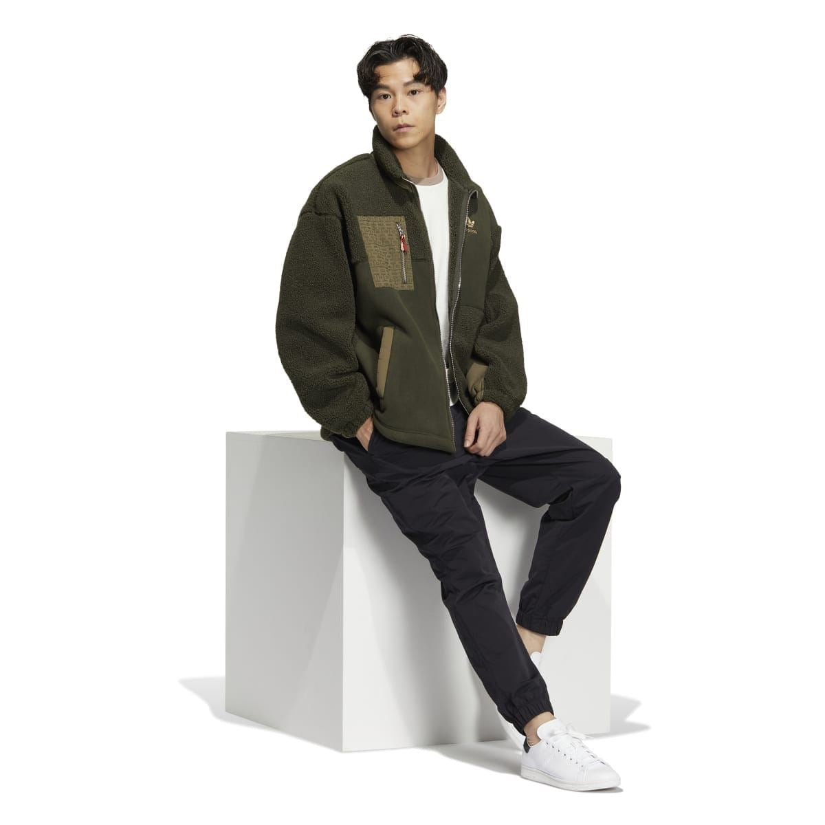 Olive green Sherpa full-zip jacket worn by model with high collar and front zip