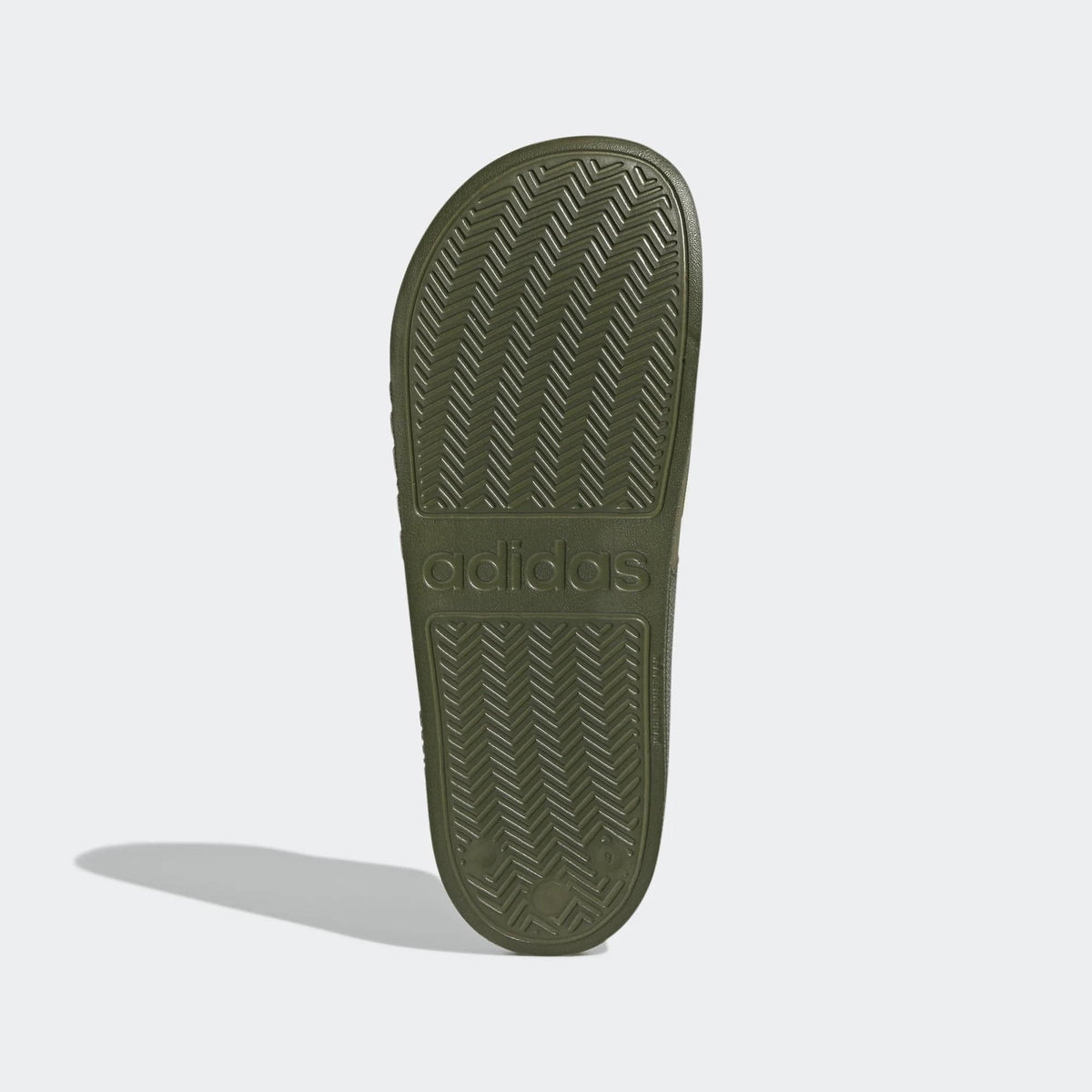 Olive Adidas slide sandal outsole with textured tread pattern and adidas branding