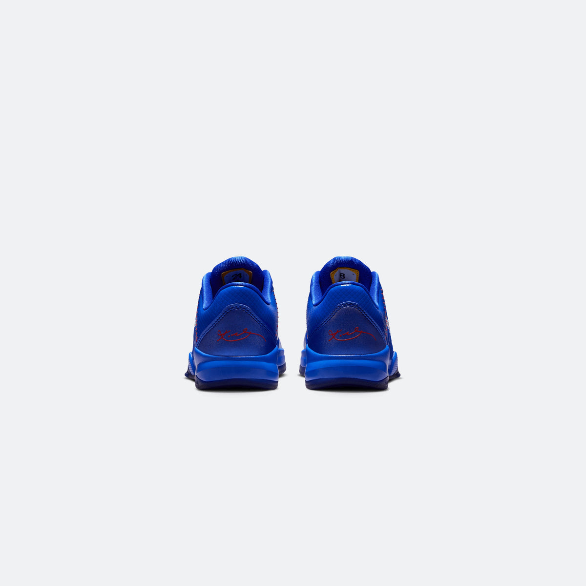 Blue Nike Kobe V low-top kids basketball shoes, heel view with red accents