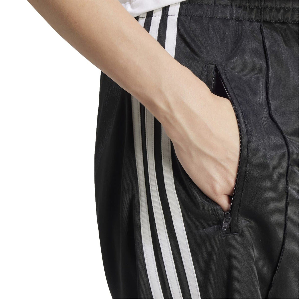 adidas Originals loose black track pants with white side stripes and zip pocket detail
