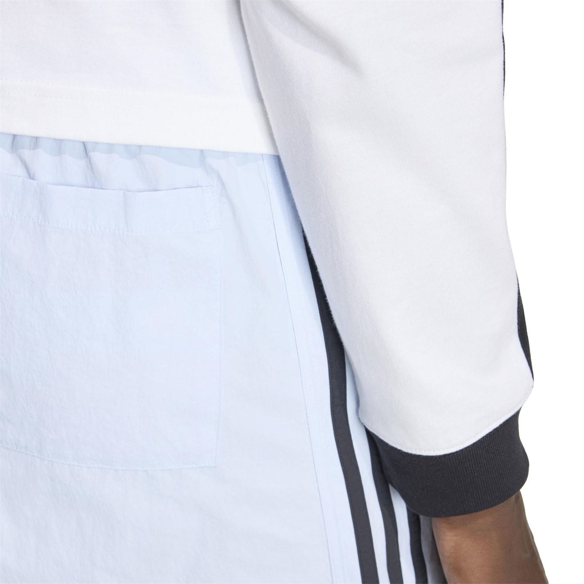 Light blue shorts close-up showing side panel stitching and elastic waistband