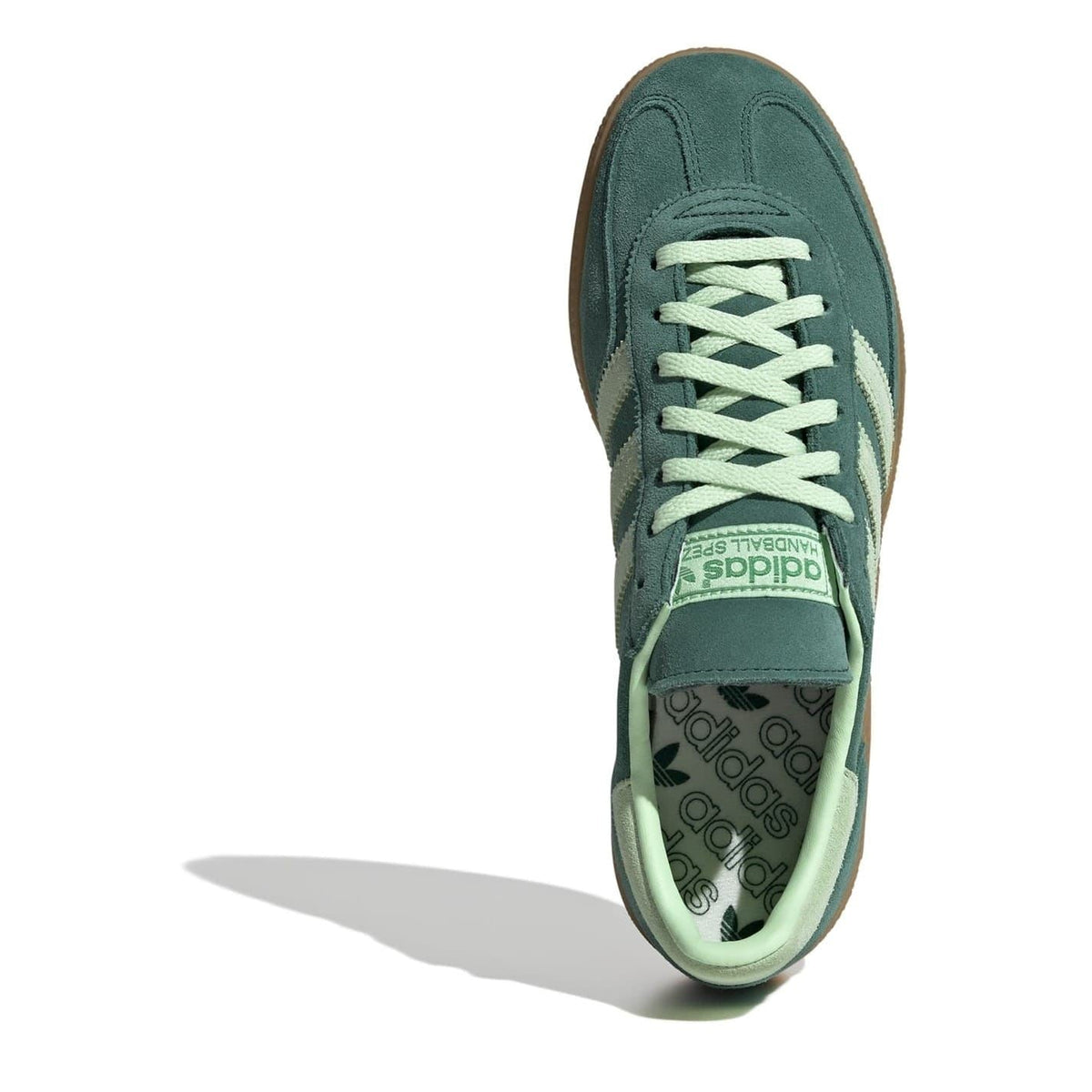 Green low-top sneakers with mint laces and striped interior lining