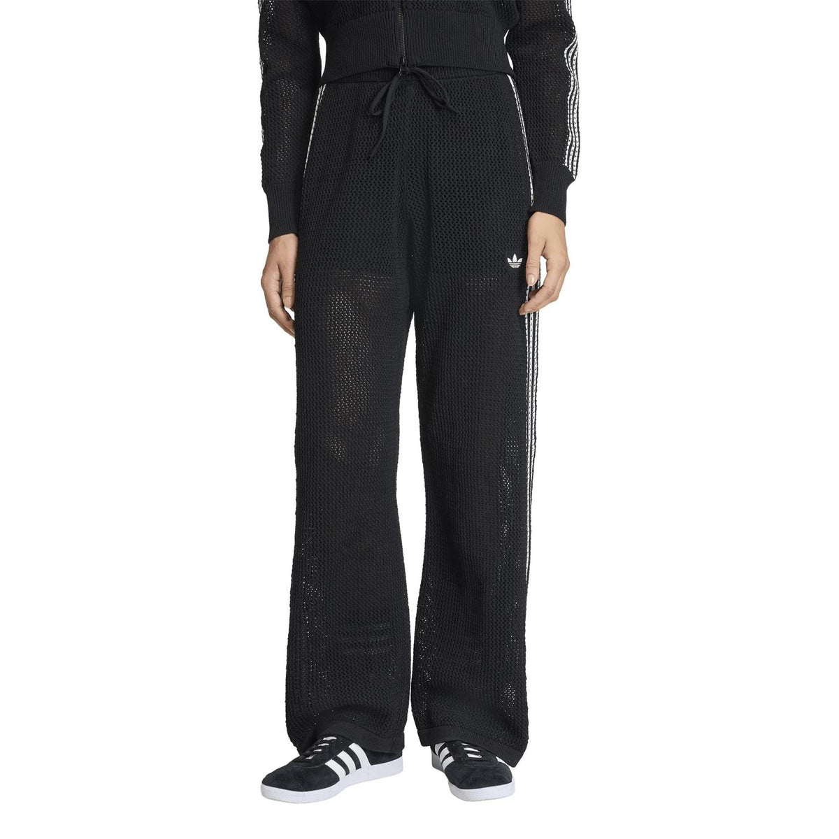 Black women's jersey joggers with drawstring waist, open hems, and adidas logo