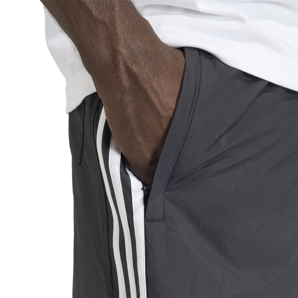 Black adidas Originals shorts close-up of side stripe and front pocket opening