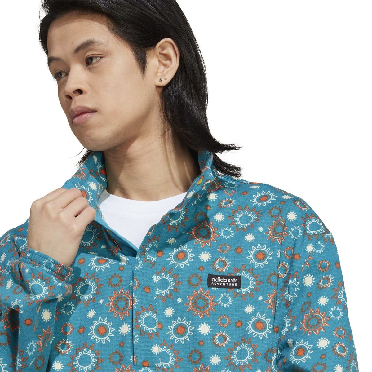 adidas hooded quarter-zip relaxed shirt close-up in teal floral print with logo label
